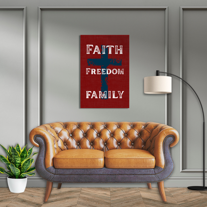 Faith Freedom Family vertical canvas art hanging above a classic tufted leather sofa in a rustic gray paneled farmhouse living room setting.