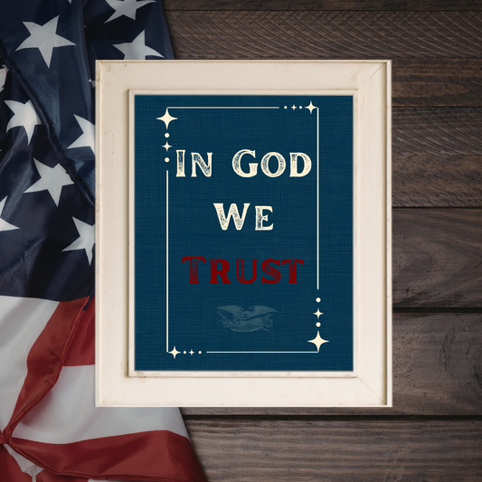 Close-up mockup of a premium dark navy linen texture wall art print featuring the words "In God We Trust" in clean cream typography, surrounded by an expanded thin border with corner stars and a faint, subtle vintage eagle watermark at the bottom.